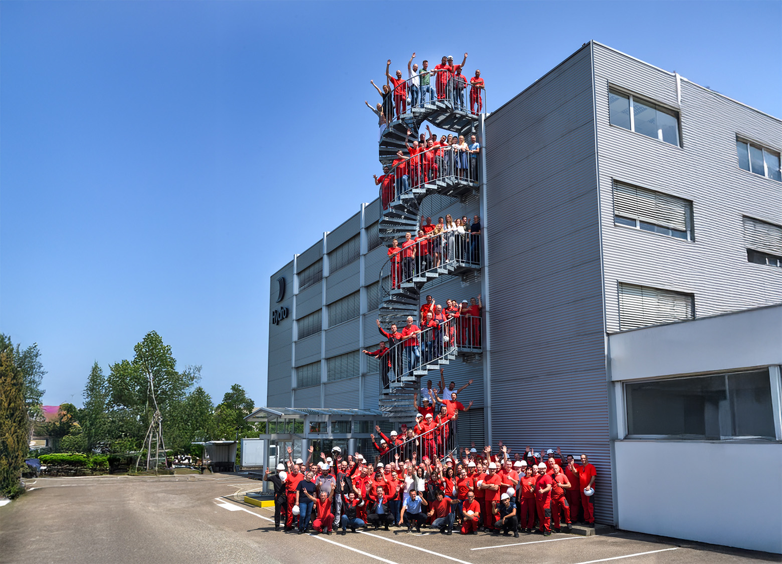 a group of people standing on a metal staircase outside a building