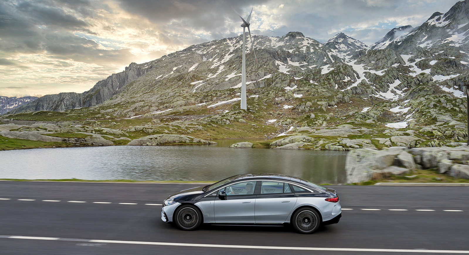 Mercedes-Benz in the mountains with windmill in the background