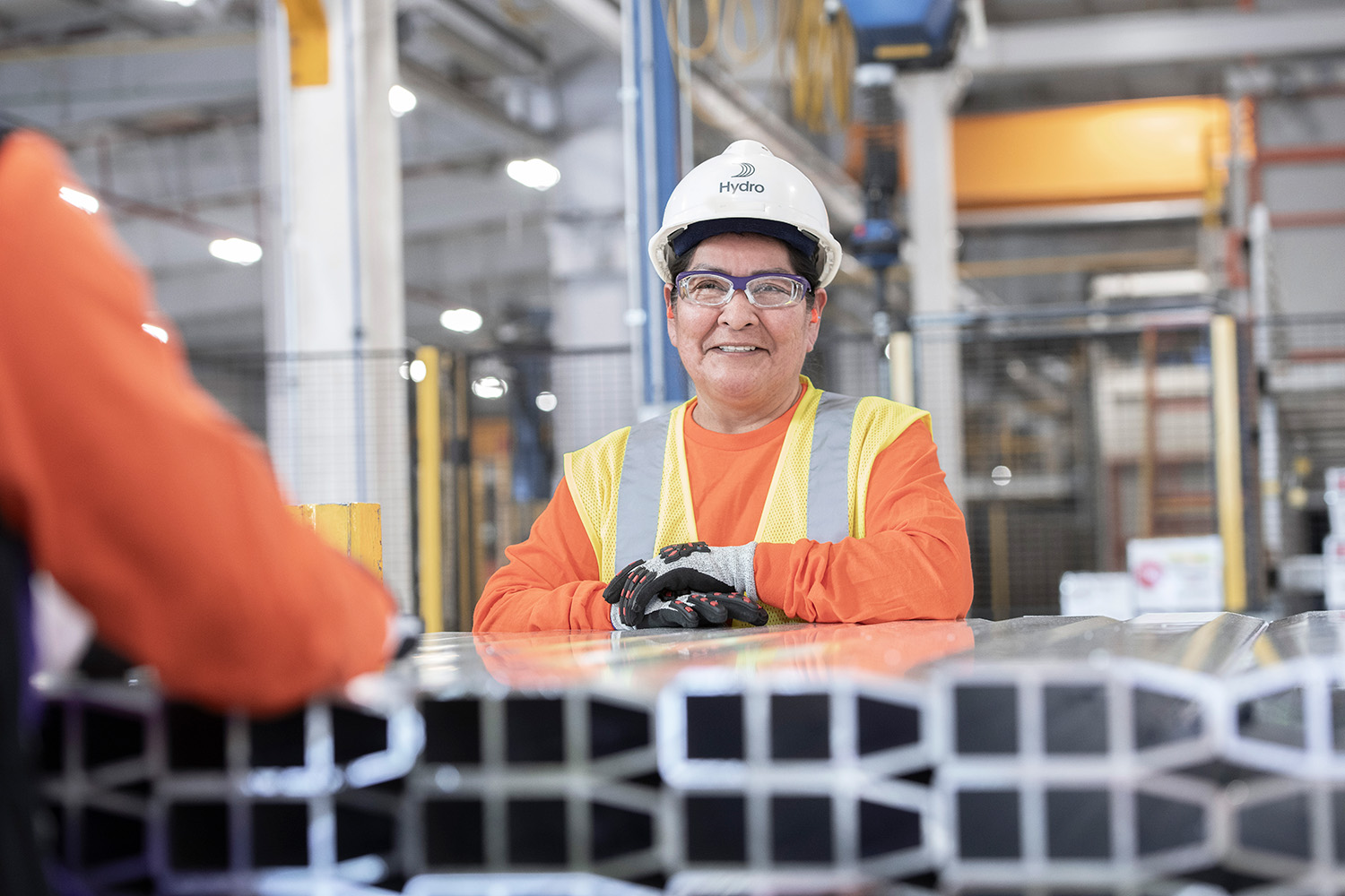 a woman wearing a hard hat and safety vest