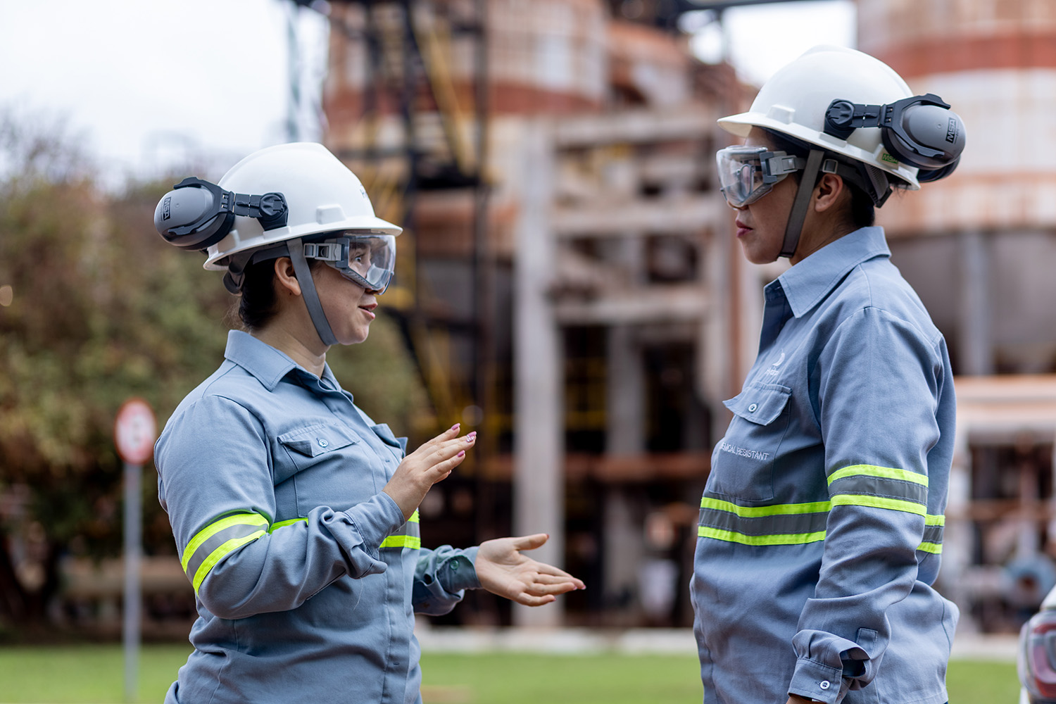 a couple of women wearing hard hats and helmets