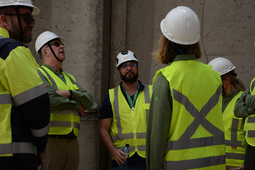 a group of people wearing hardhats and reflector vests