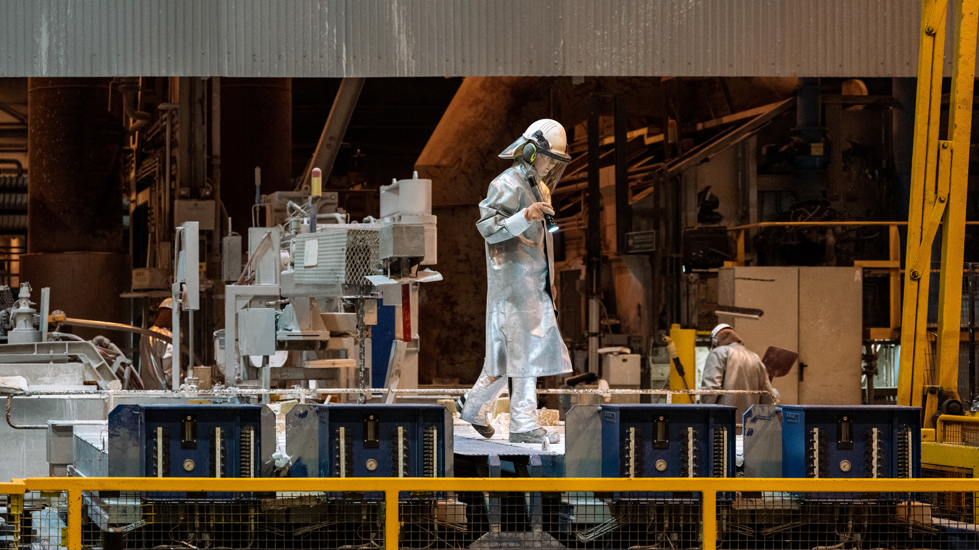 a person in a silver suit working on a machine